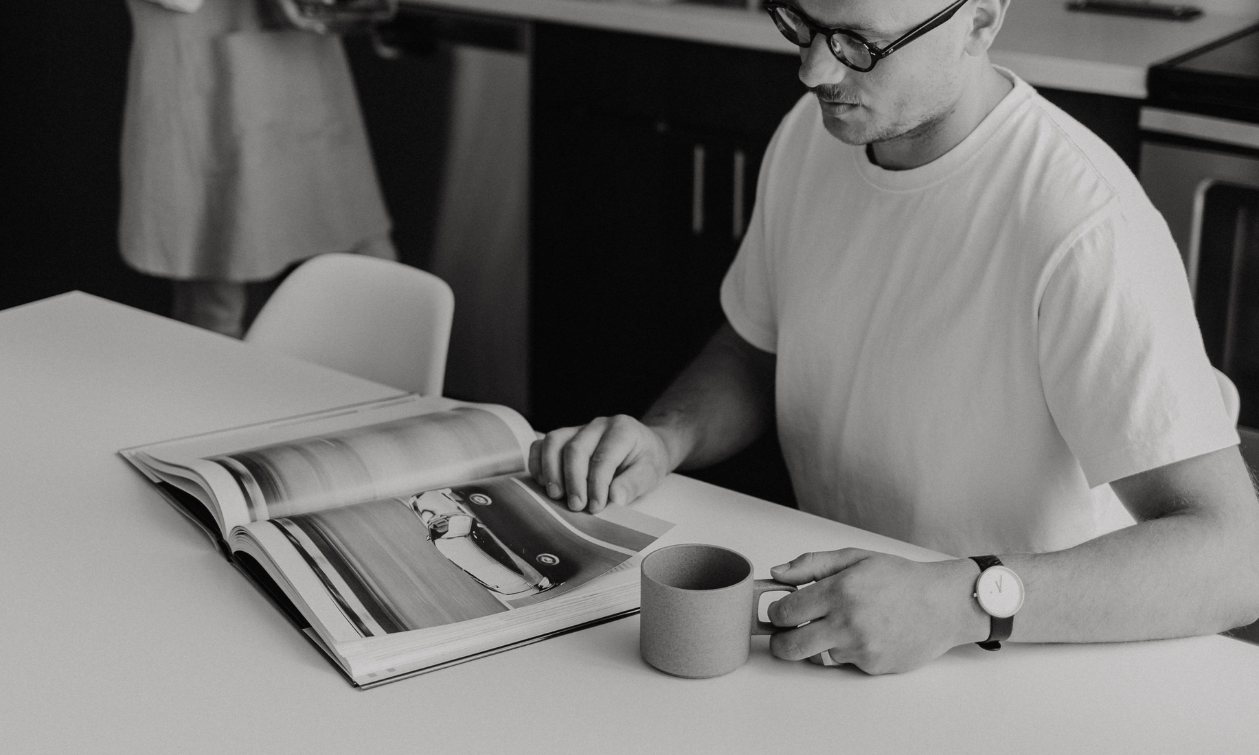 Vadim looking through a Porsche design book for inspiration.